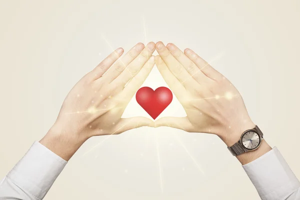 Hands creating a form with shining heart — Stock Photo, Image