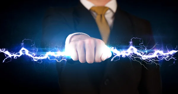 Business man holding electricity light bolt in his hands — Stock Photo, Image