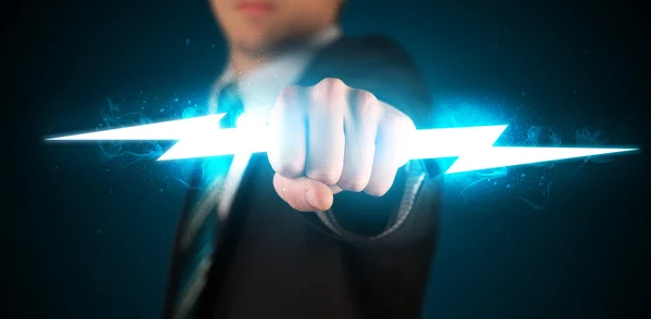 Business man holding glowing lightning bolt in his hands — Stock Photo, Image