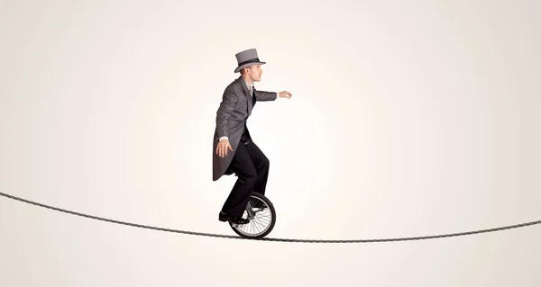 Extreme zakenman rijdt eenwieler op een touw — Stockfoto