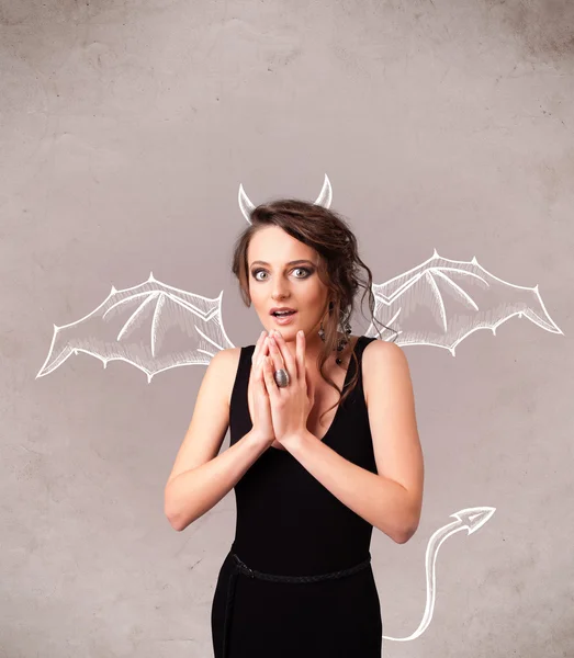 Young girl with devil horns and wings drawing — Stock Photo, Image