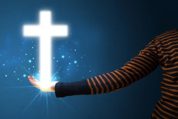 Glowing cross in the hand of a woman — Stock Photo, Image