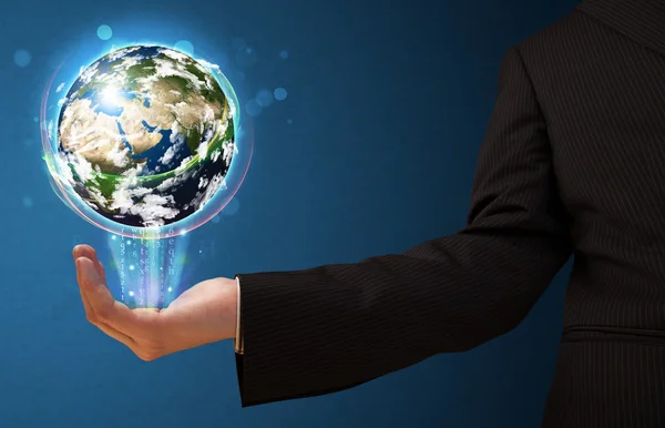 Businessman holding a glowing earth globe — Stock Photo, Image