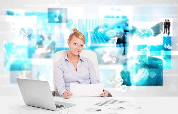 Business person at desk with modern tech images at background — Stock Photo, Image