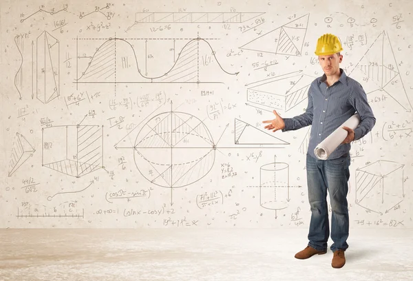 Handsome engineer calculating with hand drawn background — Stock Photo, Image