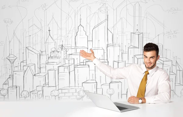 Businessman sitting at the white table with hand drawn buildings — Stock Photo, Image