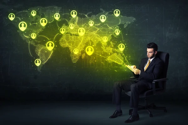Businessman in office with tablet and social network world map — Stock Photo, Image