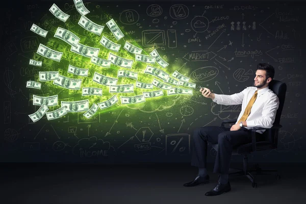 Businessman sitting in chair holding tablet with dollar bills co — Stock Photo, Image