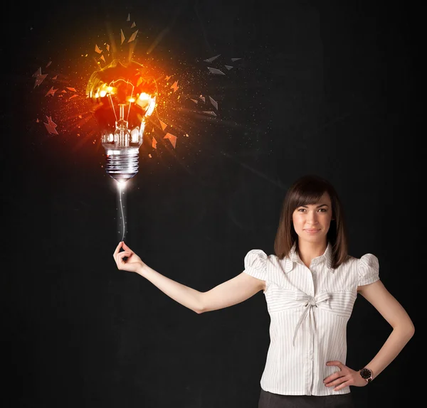 Businesswoman with an explosion bulb — Stock Photo, Image