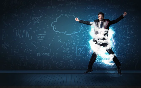 Happy business man jumping with storm cloud around him — Stock Photo, Image