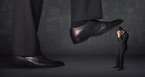 Huge leg stepping on a tiny businnessman concept — Stock Photo, Image