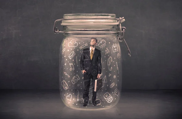 Business man captured in glass jar with hand drawn media icons c — Stock Photo, Image