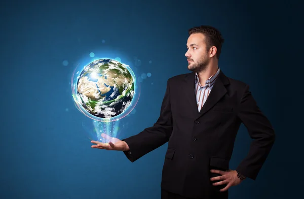 Businessman holding glowing earth globe — Stock Photo, Image