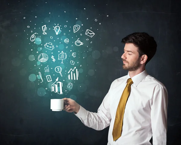 Businessman holding a white cup with business icons — Stock Photo, Image