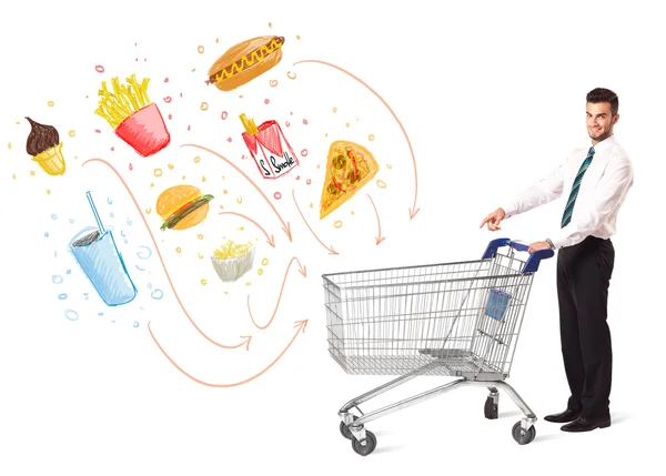 Man with shopping cart with toxic junk food — Stock Photo, Image