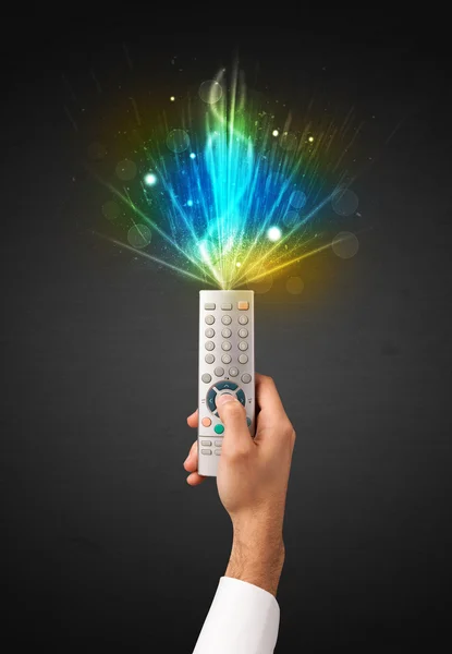 Hand with remote control and explosive signal — Stock Photo, Image