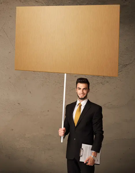Businessman with blank cardboard — Stock Photo, Image