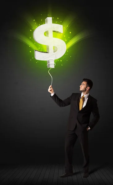 Empresário com um balão de sinal de dólar — Fotografia de Stock