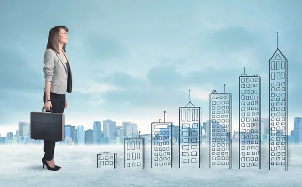 Business woman climbing up on hand drawn buildings in city — Stock Photo, Image