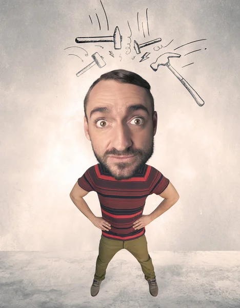 Big head person with drawn hammers — Stock Photo, Image