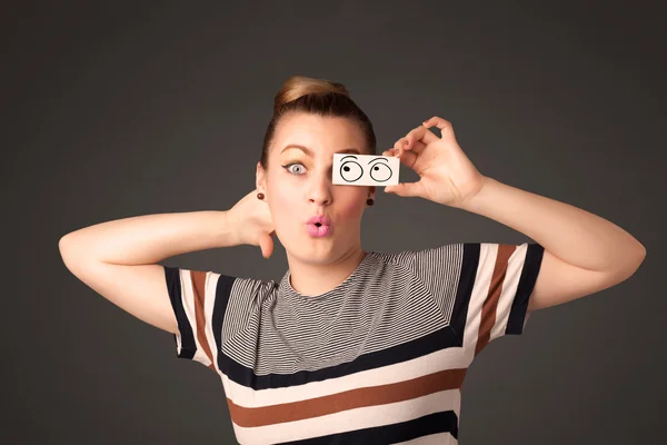 Young silly girl looking with hand drawn eye balls on paper — Stock Photo, Image