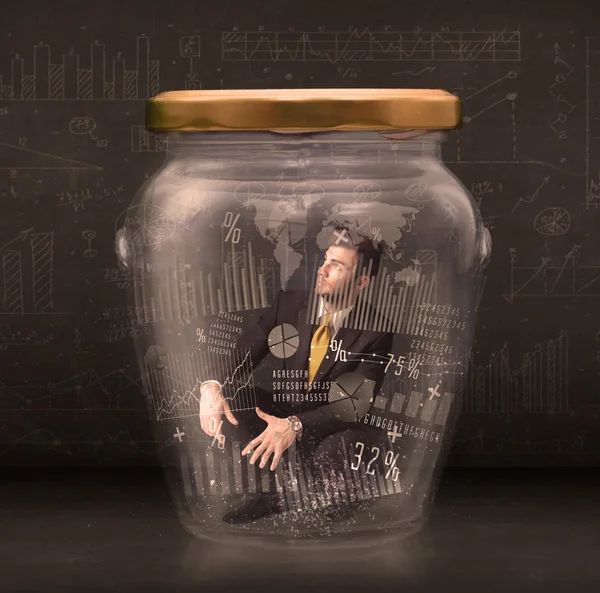 Businessman traped in jar with graph chart symbols concept — Stock Photo, Image