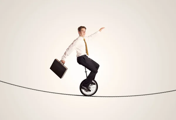 Extreme business man riding unicycle on a rope — Stock Photo, Image