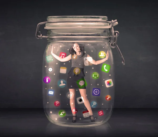 Businesswoman captured in a glass jar with colourful app icons c — Stock Photo, Image