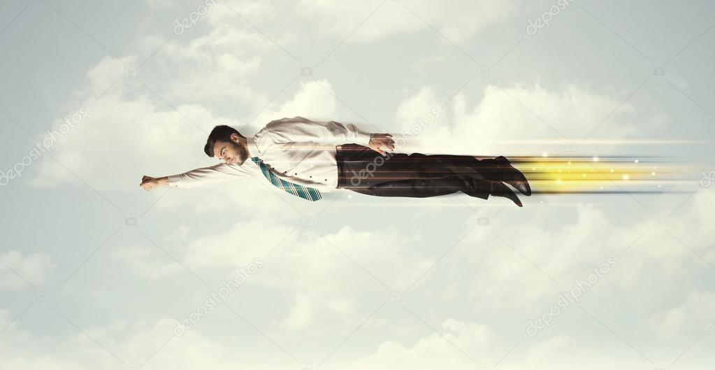 Happy business man flying fast on the sky between clouds