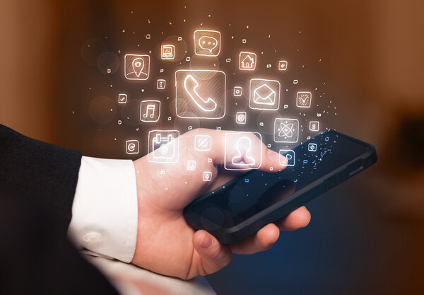 Hand holding smartphone with mobile app icons