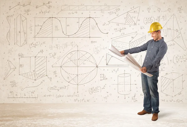 Handsome engineer calculating with hand drawn background — Stock Photo, Image