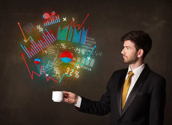 Empresário segurando um copo branco com diagramas e gráficos — Fotografia de Stock