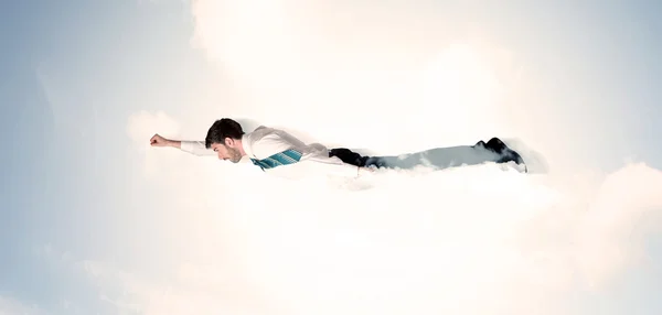 Business man flying like a superhero in clouds on the sky — Stock Photo, Image