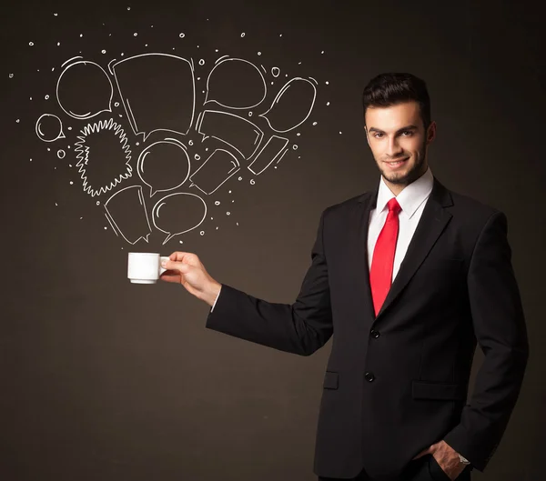 Businessman holding a white cup with speech bubbles — Stock Photo, Image