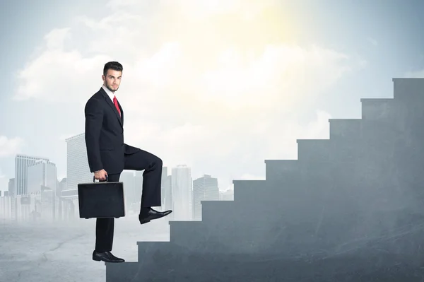Businessman climbing up a concrete staircase concept — Stock Photo, Image