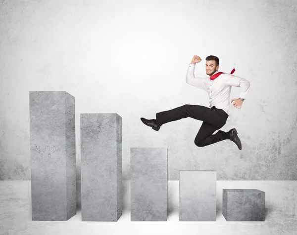 Successful business man jumping over charts on background — Stock Photo, Image