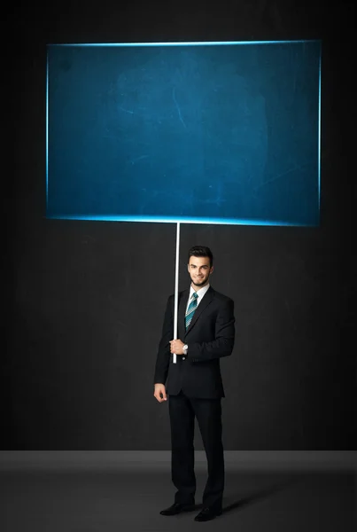 Businessman with blue board — Stock Photo, Image