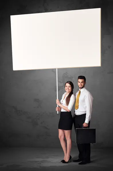 Business couple with blank whiteboard — Stock Photo, Image