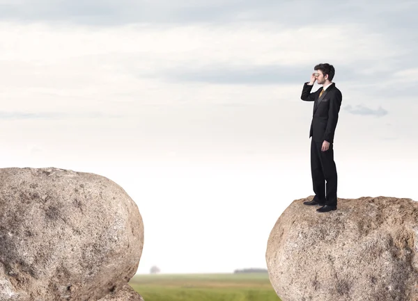 Businessman on rock mountain — Stock Photo, Image