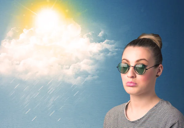 Young person looking with sunglasses at clouds and sun — Stock Photo, Image