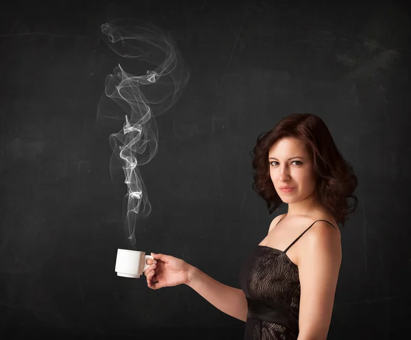 Businesswoman holding a white steamy cup — Stock Photo, Image