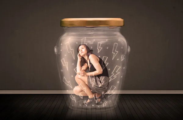 Businesswoman inside a glass jar with lightning drawings concept — Stock Photo, Image