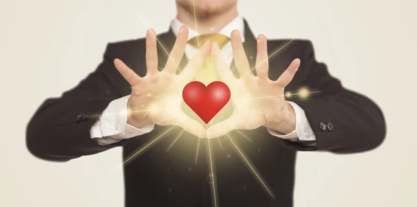 Hands creating a form with shining heart — Stock Photo, Image