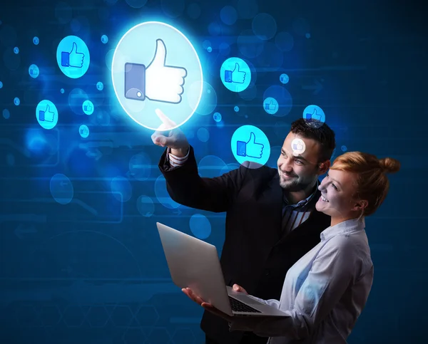 Young business couple pressing thumbs up button on modern social — Stock Photo, Image