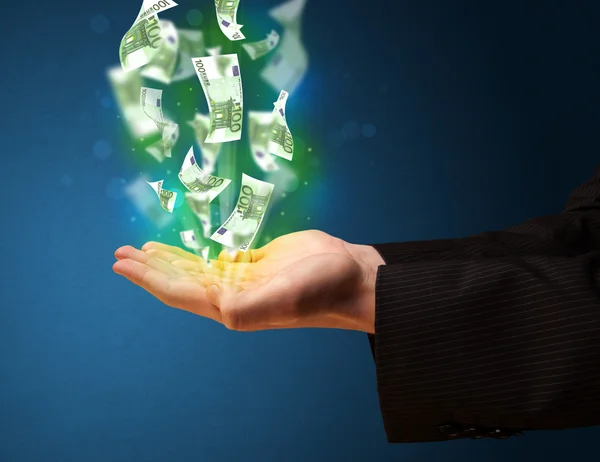 Glowing money in the hand of a businessman — Stock Photo, Image