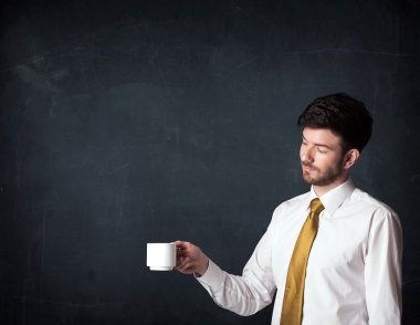 Beyaz bir bardak tutan işadamı