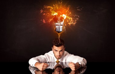 Businessman sitting under a blowing idea bulb clipart