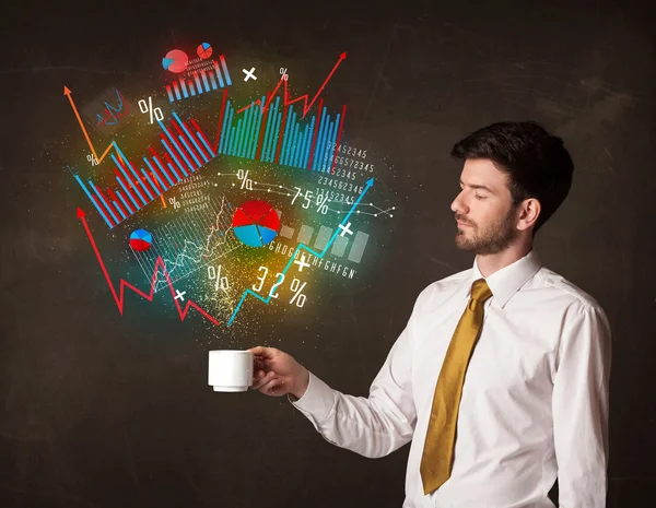 Businessman holding a white cup with diagrams and graphs — Stock Photo, Image