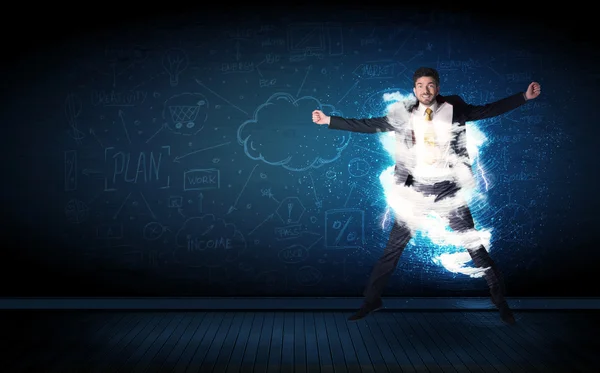 Happy business man jumping with storm cloud around him — Stock Photo, Image