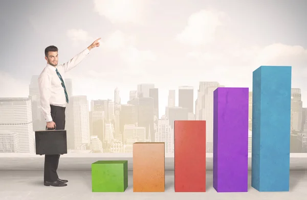 Business person climbing up on colourful chart pillars concept — Stock Photo, Image